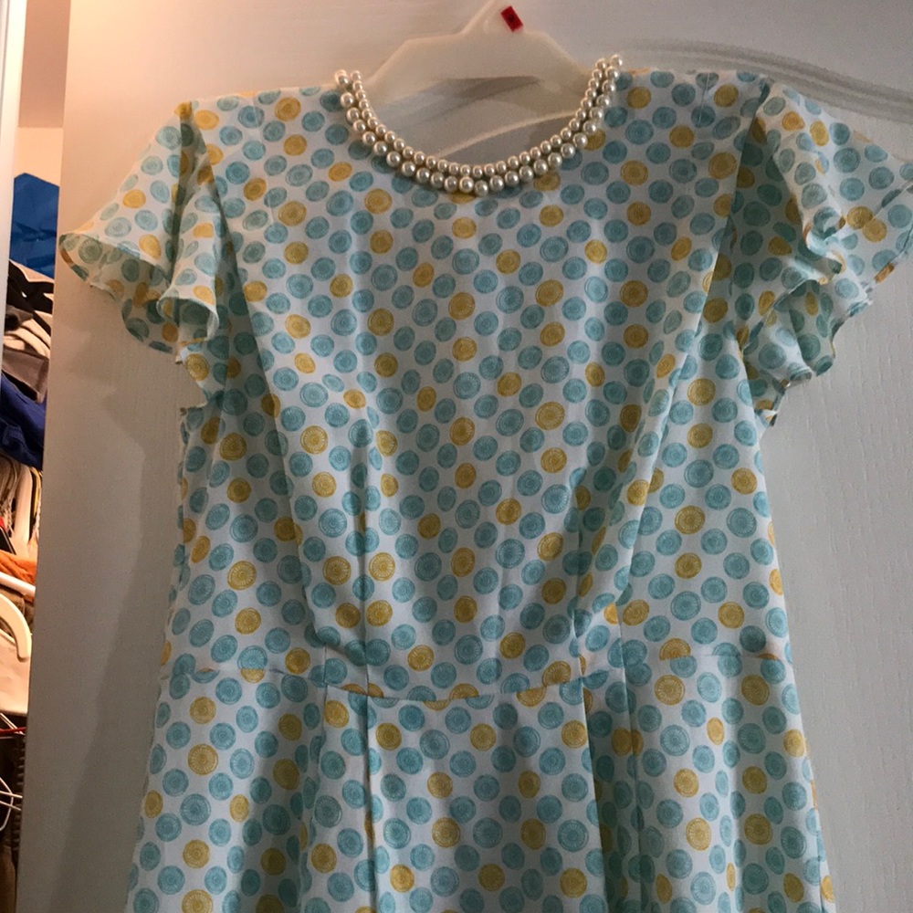 White dress with yellow and blue designs